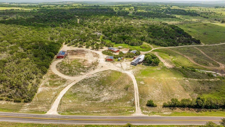 The birdseye view showcases the layout of the property, with clear views of the cabin and surrounding land. It provides a unique perspective of the space, emphasizing the peaceful and expansive nature of the area.