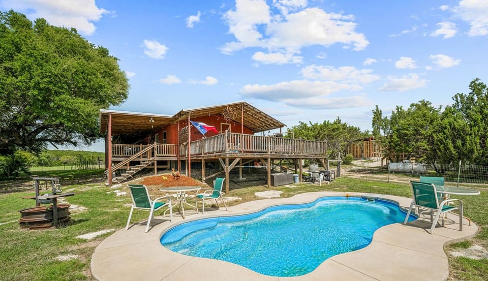 Relax on the spacious wrap-around porch and enjoy the stunning pool area, perfect for swimming or lounging. This outdoor space offers the ideal setting to unwind while enjoying the scenic surroundings.