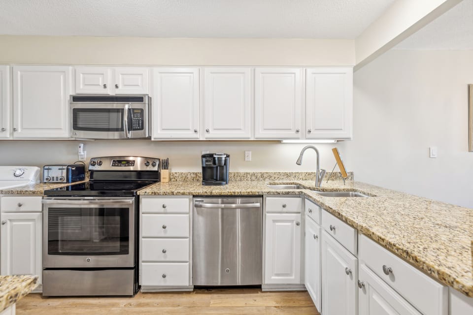 Fully stocked kitchen with stainless steel appliances