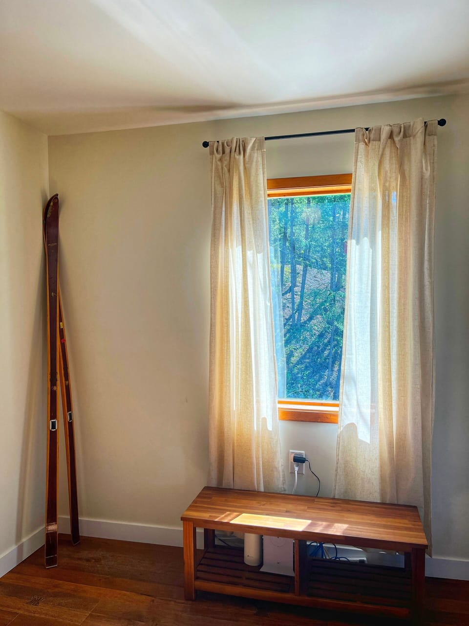 Snuggle up in this cozy room with natural light streaming through soft curtains.