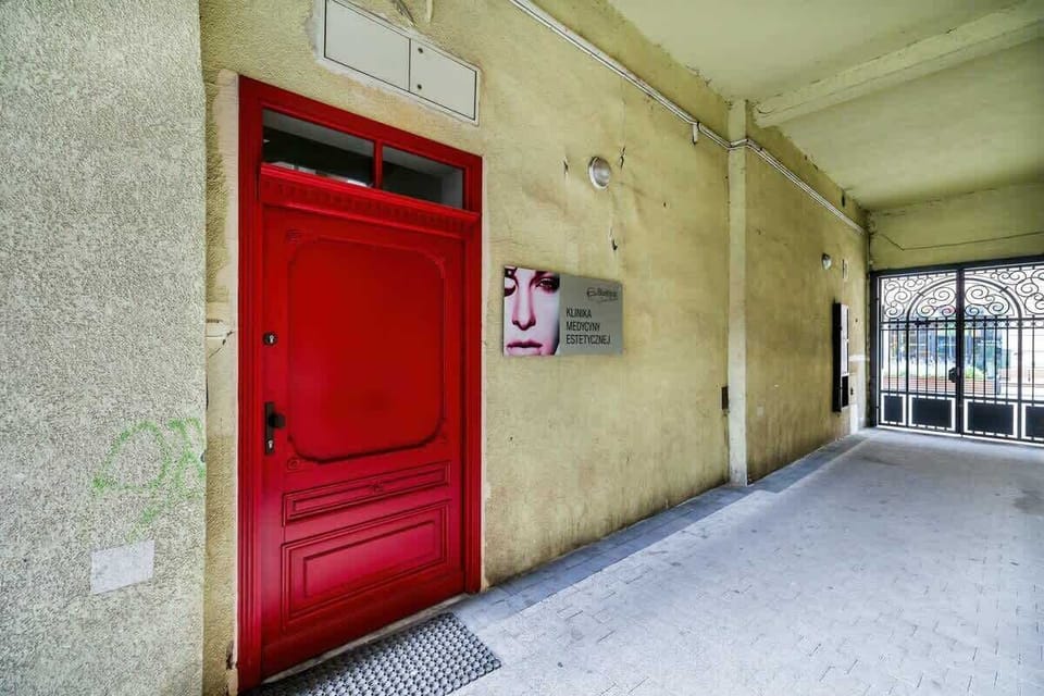 Rustic entrance hallway with authentic city charm and red door detail.