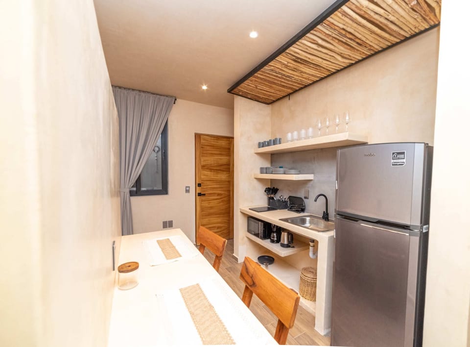 a kitchen with table and refrigerator in Tulum vacation rentals