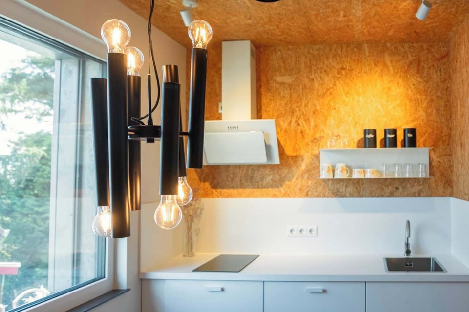 Modern kitchenette with dining table and warm wood accents
