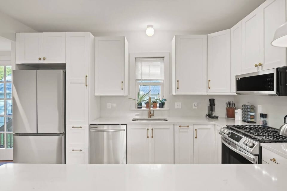 Stove, oven, microwave, dishwasher, and full fridge