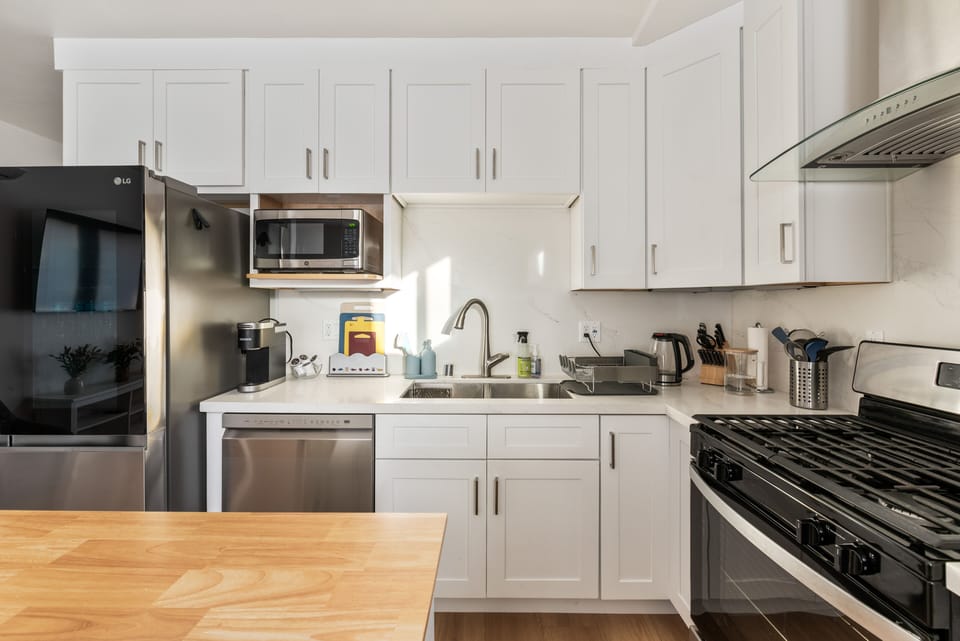 Kitchen with microwave oven, dishwater, refrigerator and cupboard storages