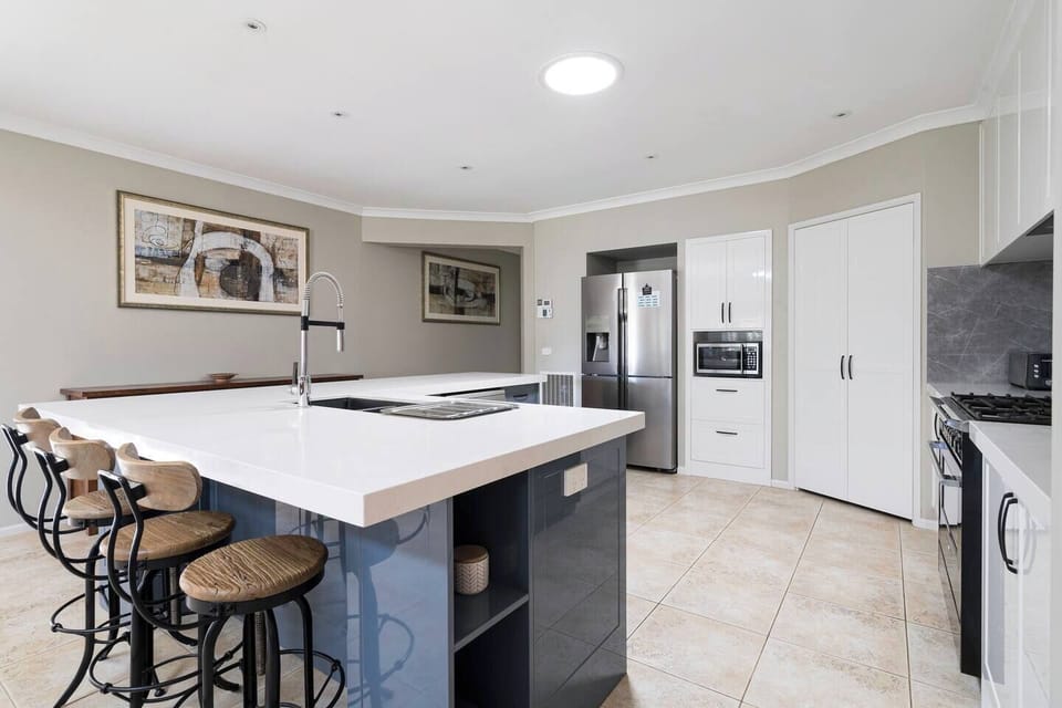 Fully equipped with modern appliances and cooking utensils, the kitchen makes it easy to prepare meals at home.
