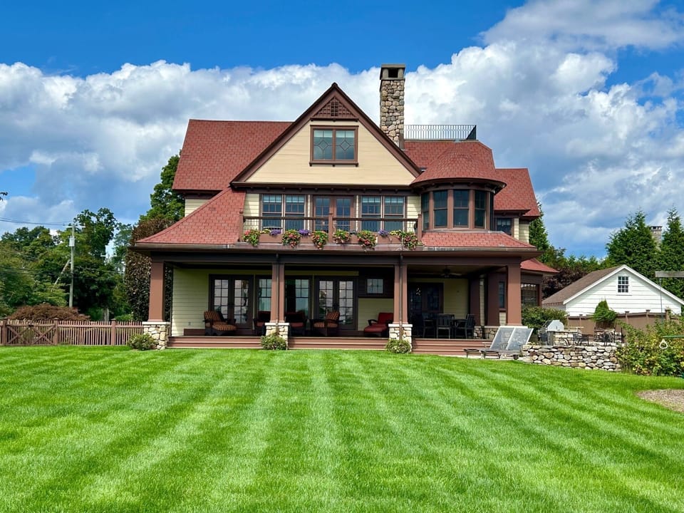 View looking back from the water, with wrap-around porch.