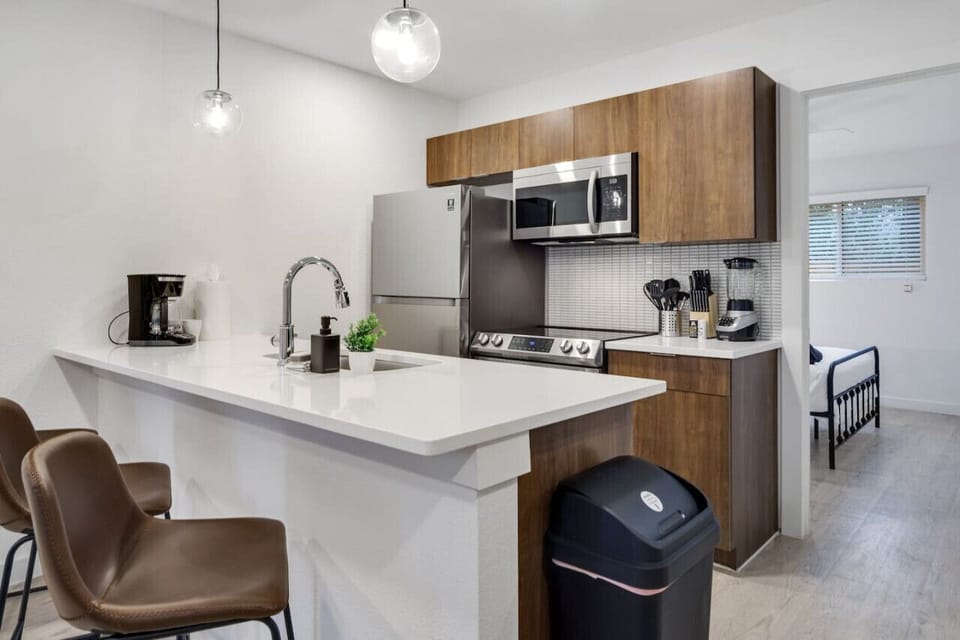 As you open the kitchen, you discover an assortment of coffee pods, and sugar, ensuring you have everything you need for a perfect morning or afternoon pick-me-up.