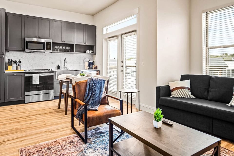 The living room’s cozy vibe makes it the perfect spot to relax, with ample seating and a warm ambiance.