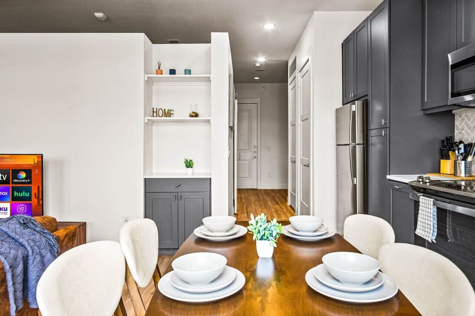 Set the table for memorable meals in this beautifully arranged dining area. With elegant place settings and a charming centerpiece, it's perfect for hosting dinner parties or enjoying family dinners in a cozy and stylish atmosphere.