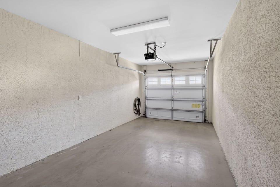 Private one car garage with an automatic overhead door.