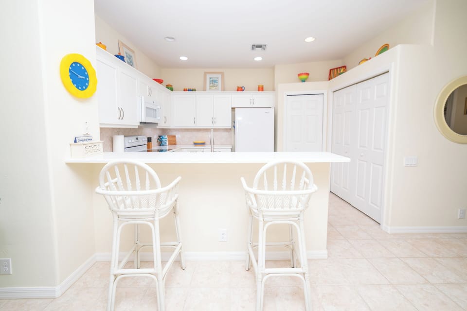 Fully-equipped kitchen with modern appliances and breakfast bar.