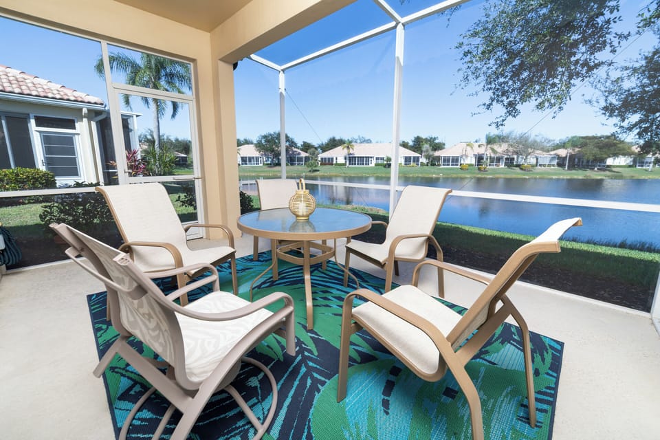 Covered lanai offers the perfect lakefront escape with comfortable seating and serene water views.