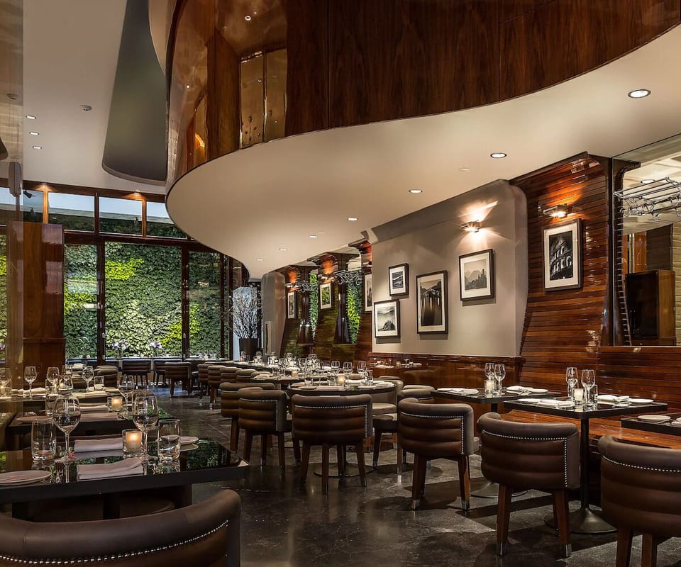 Dine beneath warm wood curves in an upscale, buzzing room.