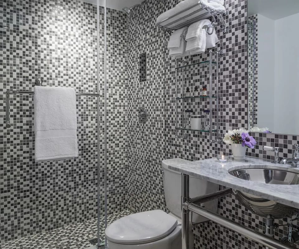 Refresh in a sparkling mosaic shower with fluffy towels ready.