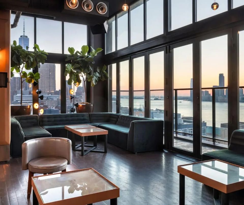 Unwind in a sunlit lounge with sweeping waterfront skyline views.