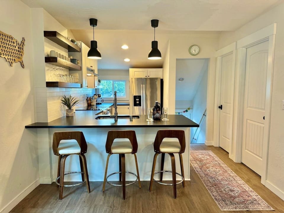 Three stools at the island for coffee, breakfast, or keeping the cook company.