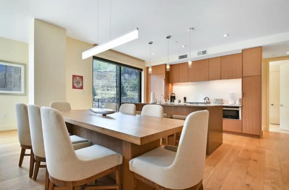 Bright dining space with modern furnishings and outdoor views.