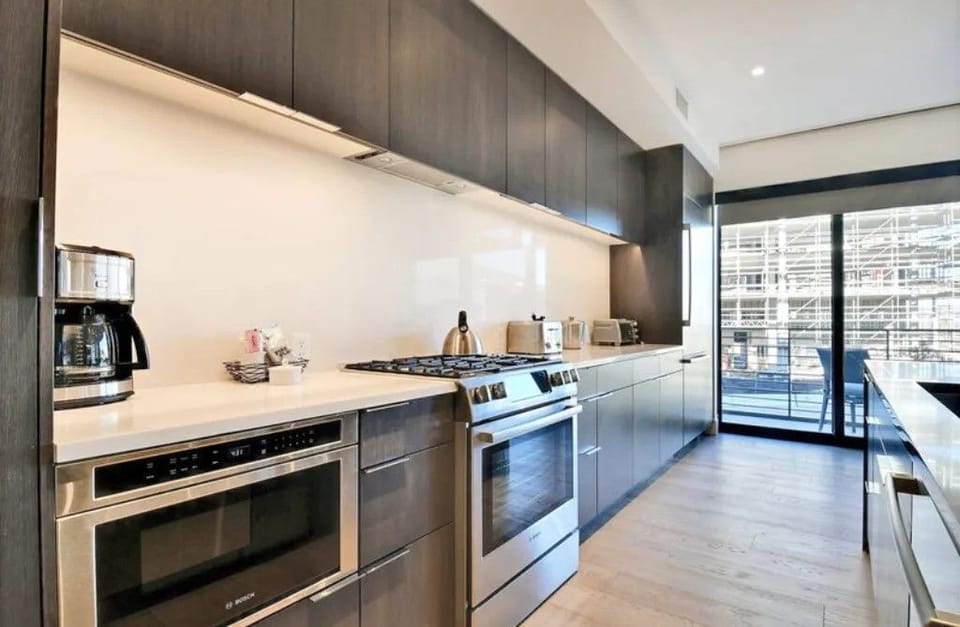 Fully equipped kitchen with stainless steel appliances.