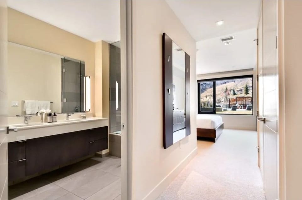Spacious bathroom with double sinks and upscale fixtures.