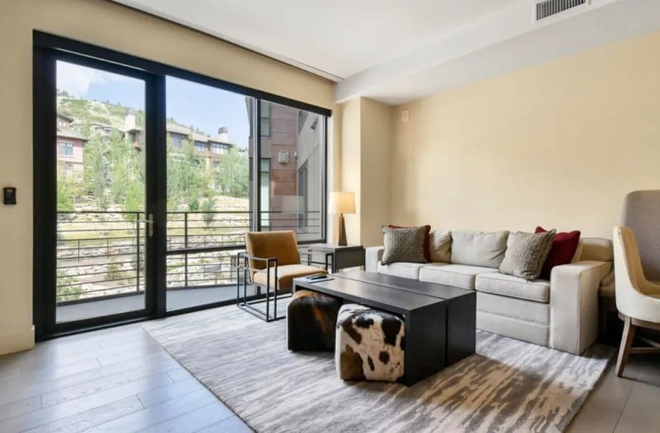 Bright living area with large windows and stylish decor.