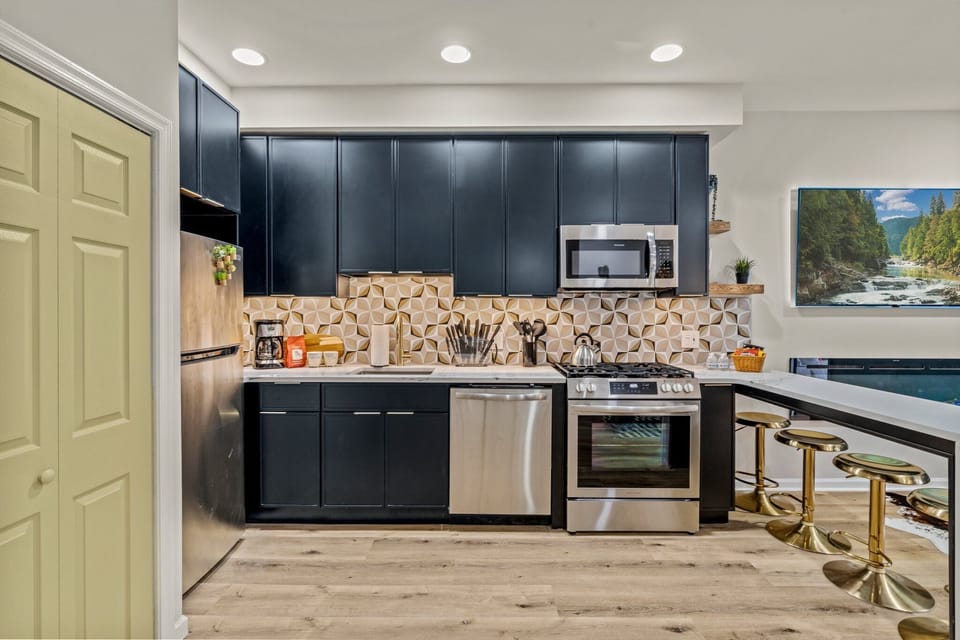 Cook or sip coffee in this striking modern kitchen with bold geometric tile and designer finishes.