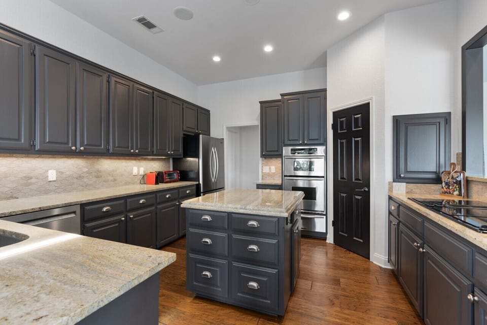 Modern kitchen with a spacious island and ample counter space, perfect for cooking and gathering.