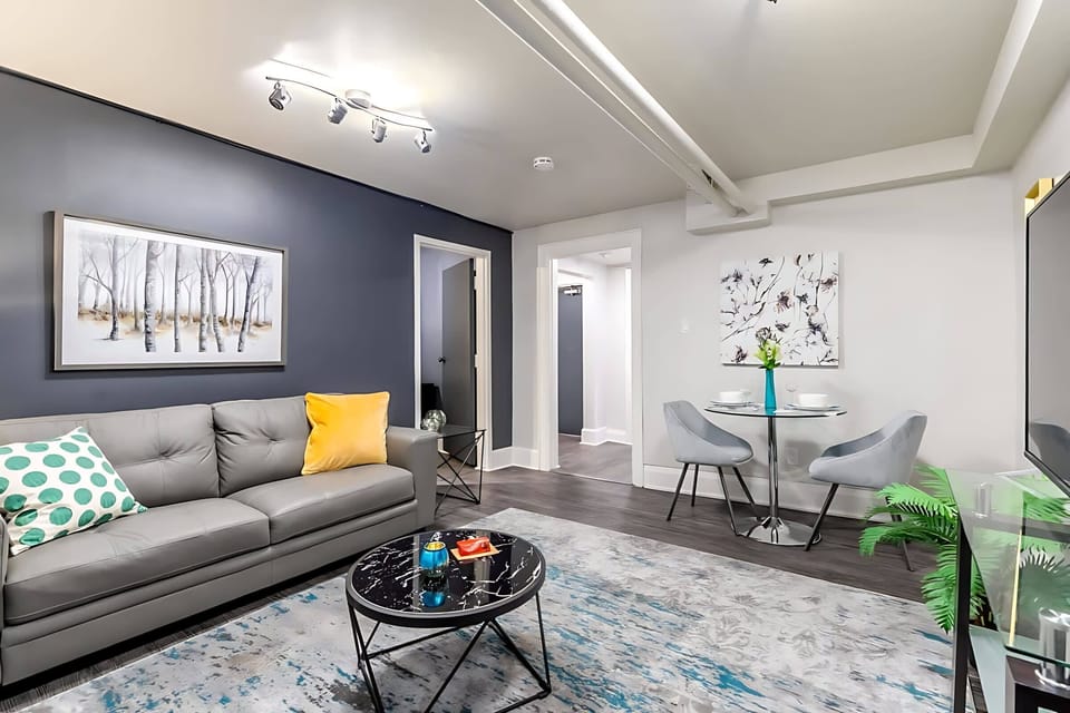 Spacious Living Room With Modern Decor And A Cozy Dining Area For Two