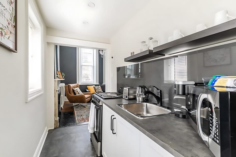 Functional Kitchen Setup With Easy Access To The Stylish Living Room