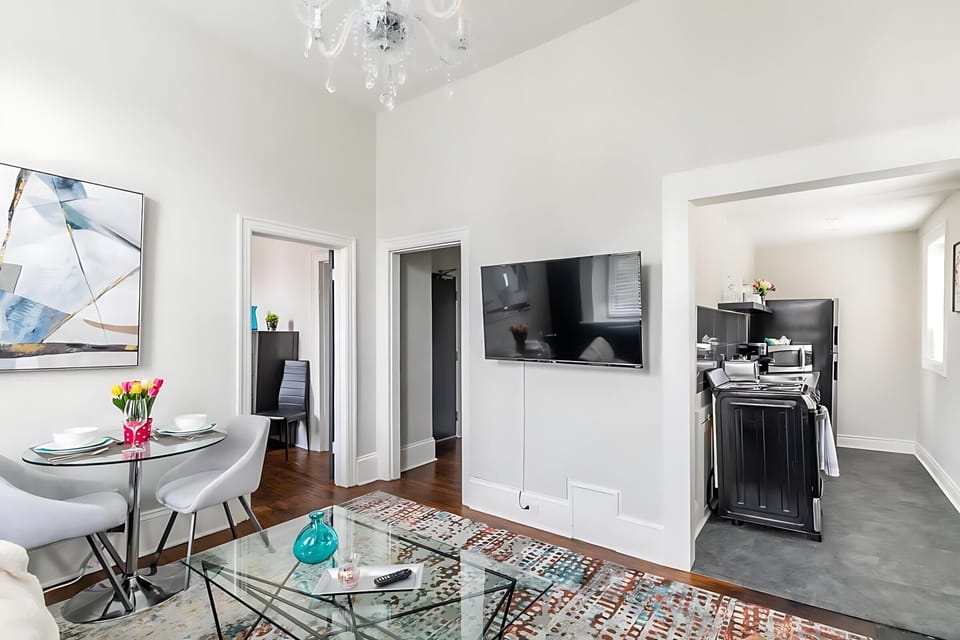 Bright Living Area With A Smart TV And Open Access To The Kitchen