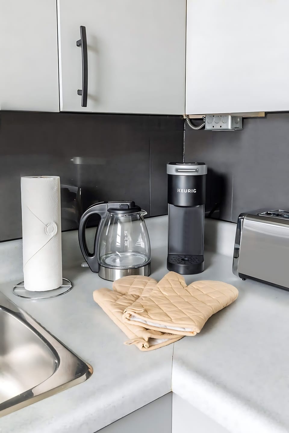 Well-Equipped Coffee Station With Oven Mitts And Kettle
