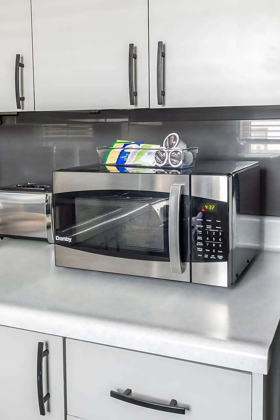 Modern Microwave With Coffee And Tea Essentials Nearby