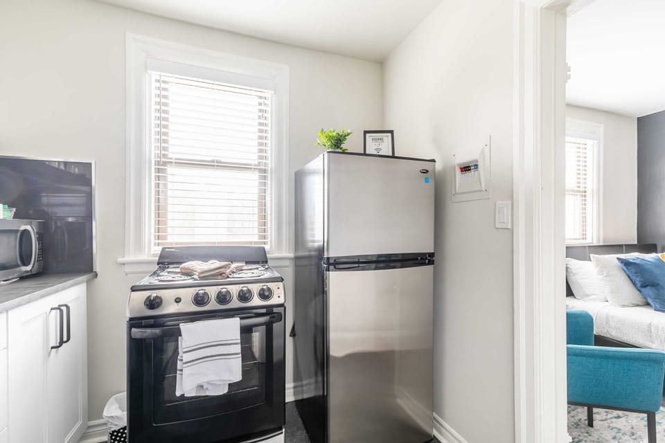 Fully Equipped Kitchen With Sleek Countertops And Modern Appliances