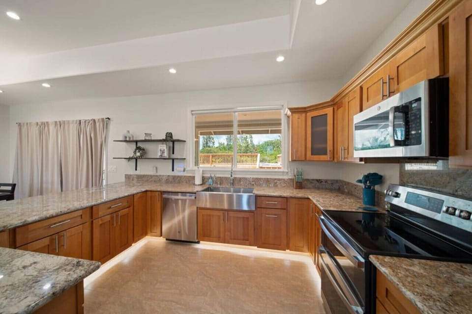 Our kitchen boasts granite countertops, soft toe kick lights, and stainless steel appliances