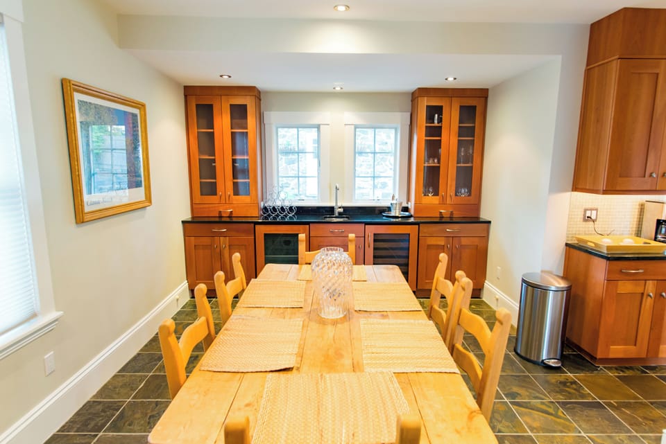 The dining area has an additional bar area with modern appliances. 