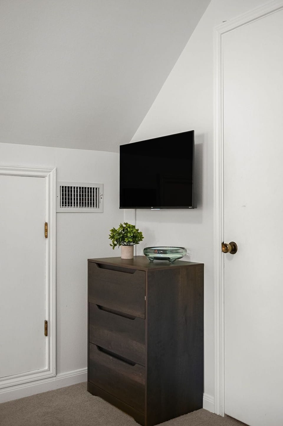Charming detail: The wood drawer is beautifully complemented by a stylish plant