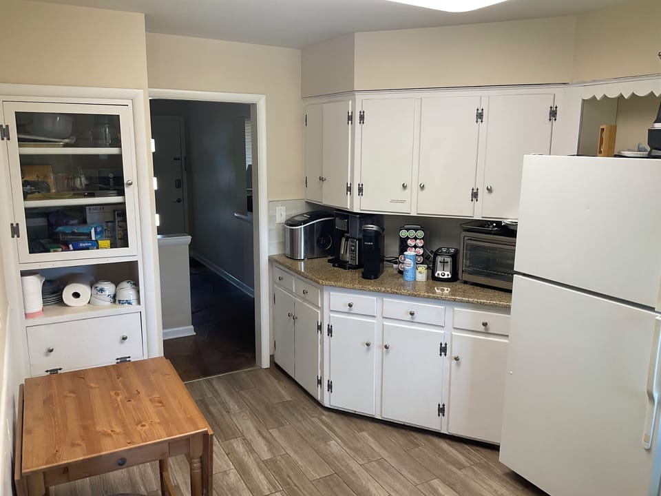 Regular coffee maker, toaster/air fryer, prep/table with wings, pots, pans, etc.