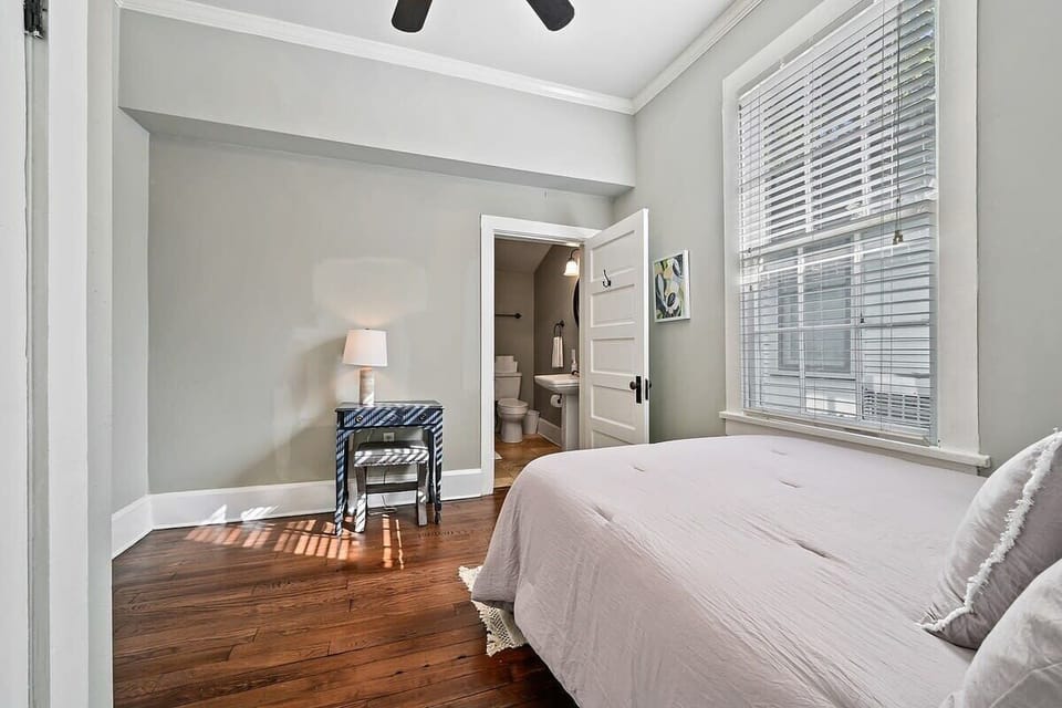 The second bedroom with a full size bed  located off the kitchen. There is a sweet little desk perfect for a quick zoom call. 