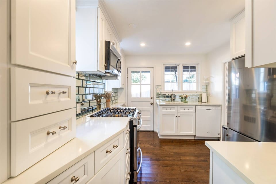 The newly-renovated kitchen sparkles at the back end of the home.