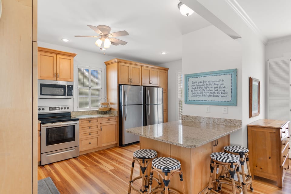 Cook memorable meals in your fully equipped kitchen with granite counters, stainless appliances, and cheerful breakfast bar seating.