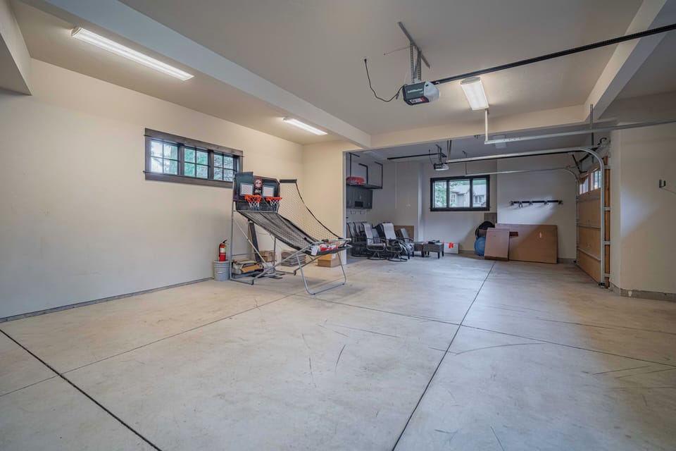 Challenge yourself to a game of basketball in your private garage game room, complete with hoop and ample space for fun.