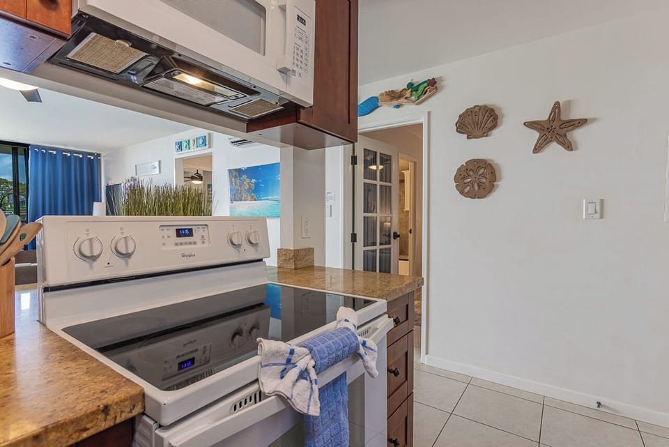 Your fully equipped kitchen features modern appliances and charming coastal decor, perfect for preparing memorable meals during your stay.