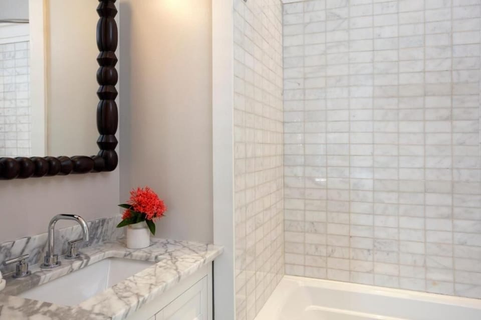 Refresh in a bright bath with marble vanity details.