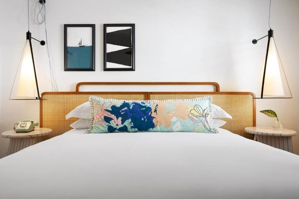 Sink into a plush king bed under warm designer lighting.
