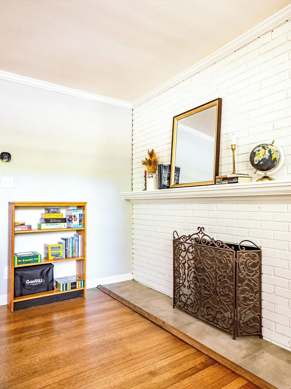 Decorative fireplace and bookshelf w/games