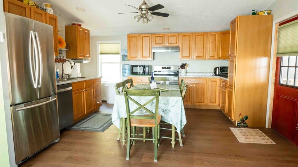 Highlights of the kitchen include seating for 6, a Keurig coffee machine with provided pods, a dishwasher, complimentary pure spring water dispenser, a microwave, a toaster oven, and plenty of various baking dishes, utensils, and spices.