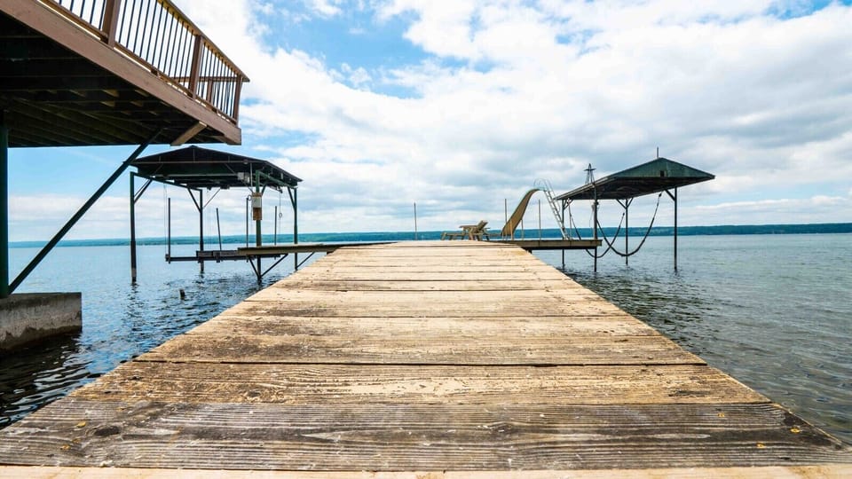 A private dock with a large sun deck, 2 boat lifts and a waterslide.