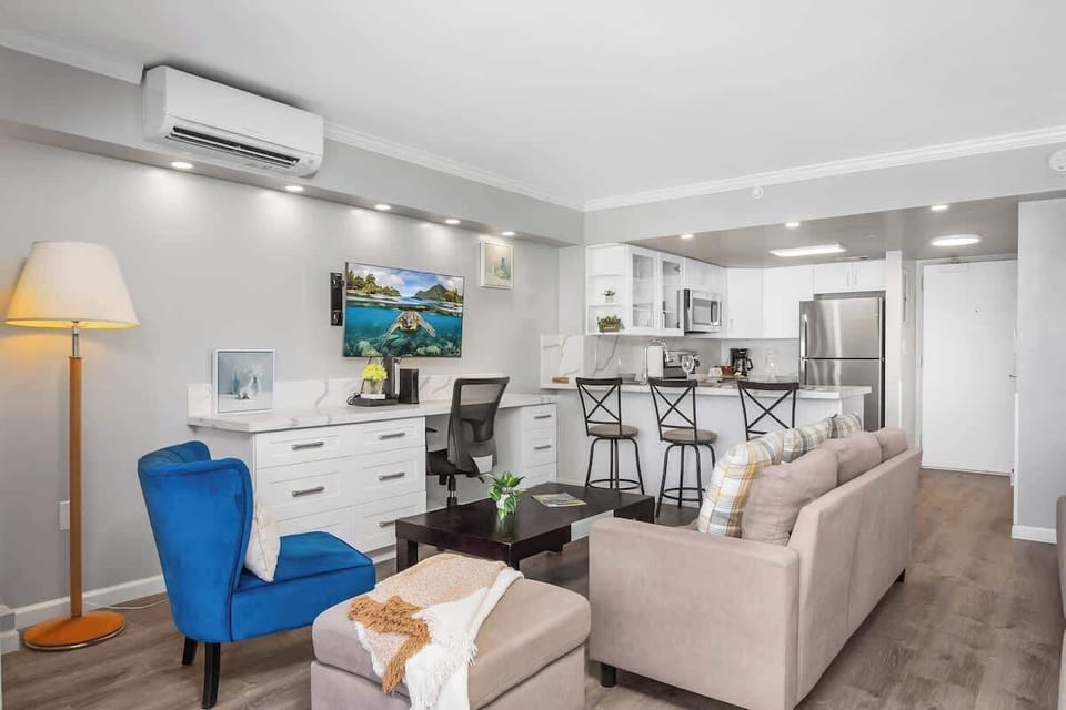 Your living area with a regular sectional sofa, accent chair, coffee table, and a 43'' smart TV.
