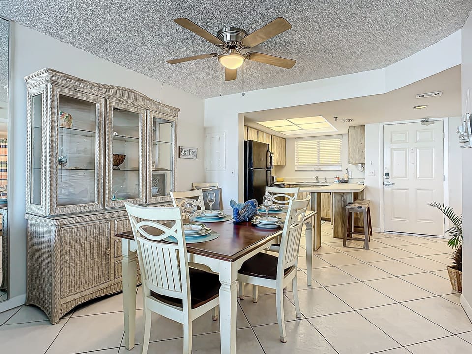 Beautiful dining setup with ocean-inspired decor, adjacent to the kitchen for easy access and family meals.