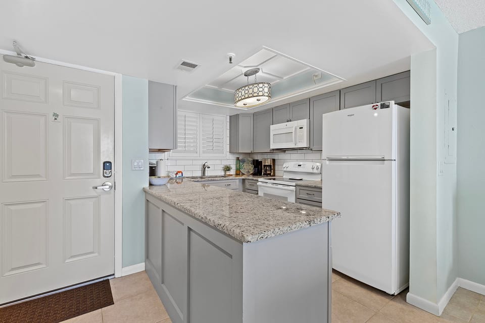 Cook in style with granite countertops, sleek appliances, and ample storage in this bright, functional kitchen.